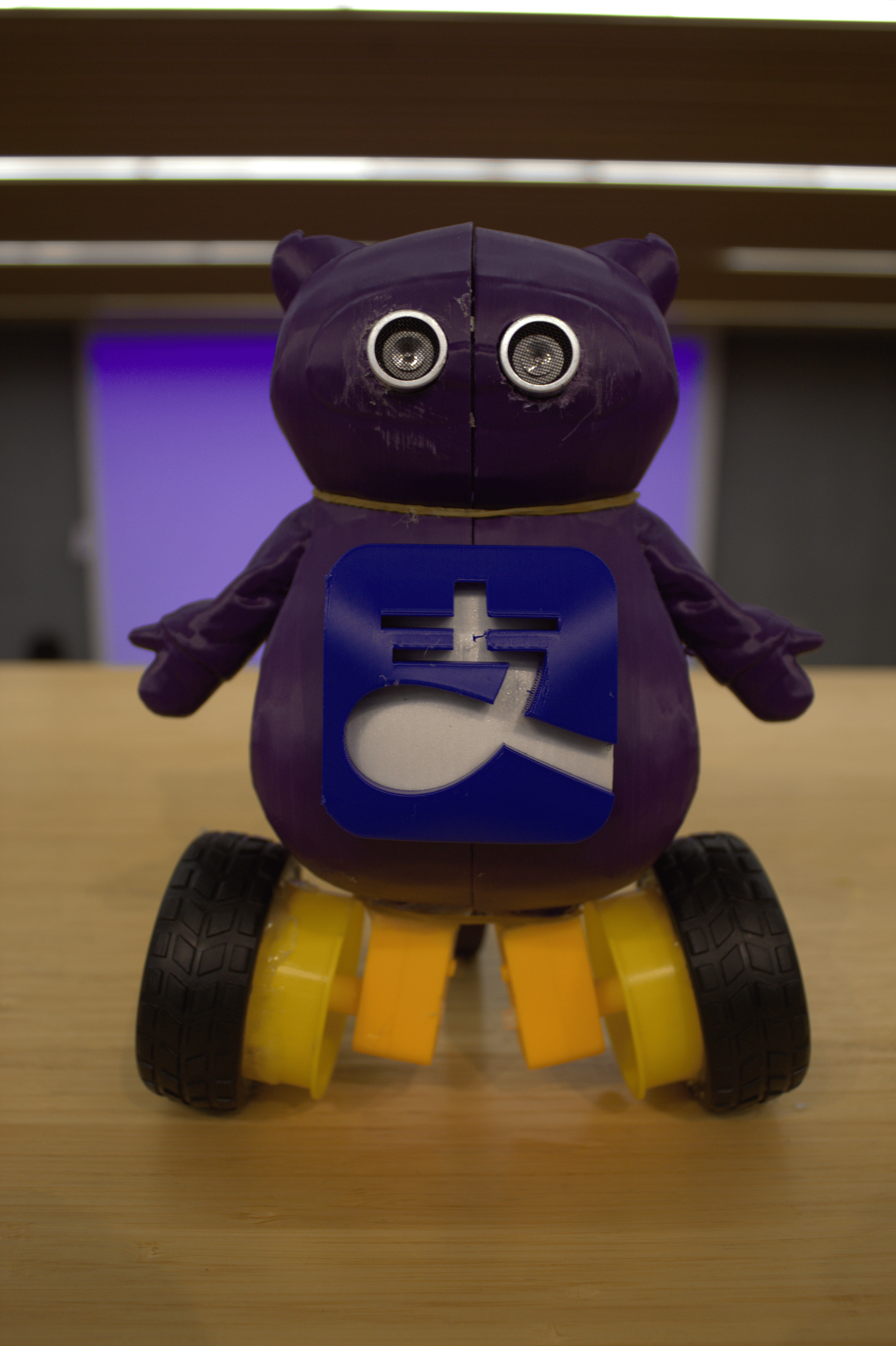Front-angle photo of the purple wheeled AliPayBot prototype on a tabletop.
