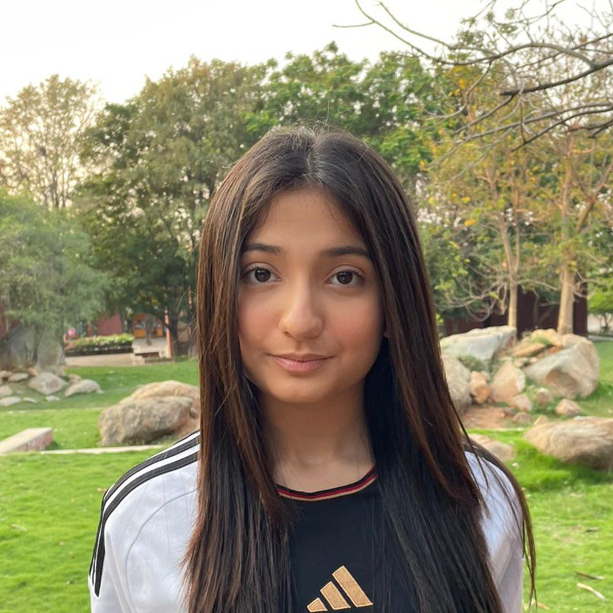 Outdoor portrait of a young woman wearing a black shirt.
